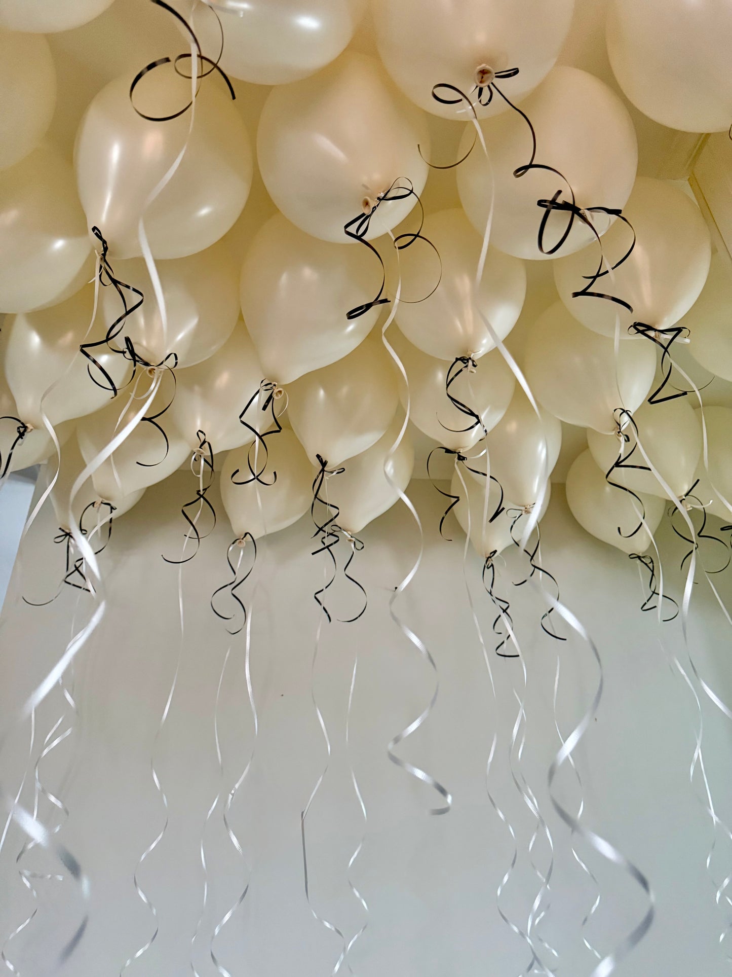 Coquette Balloons with helium-filled biodegradable balloons and decorative bows.