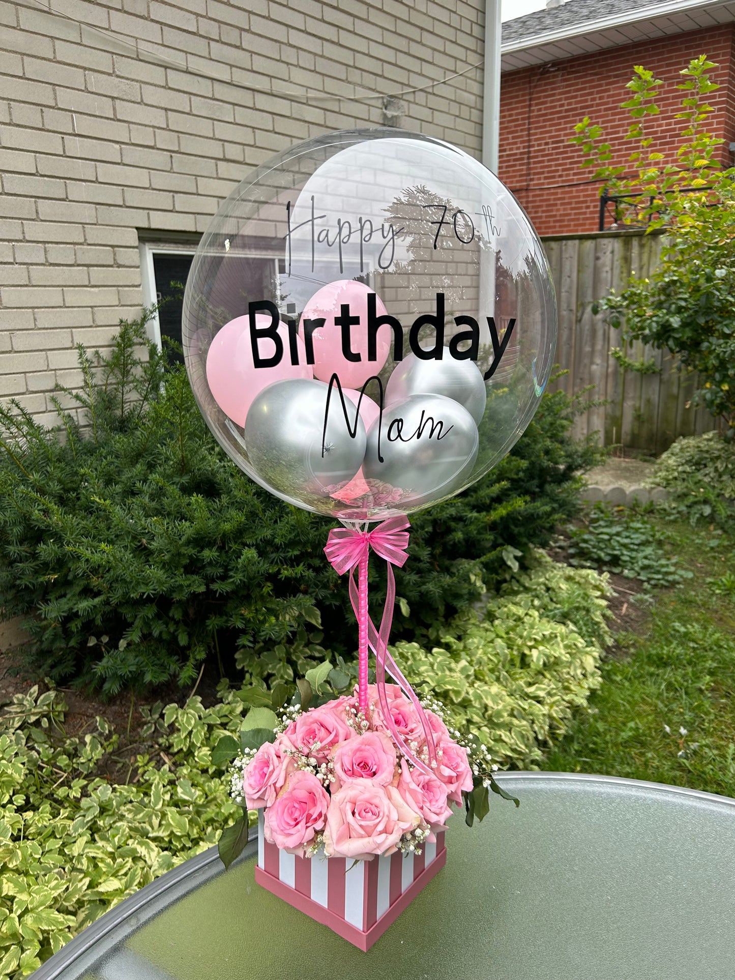 Elegant Rose Box with Bobo Balloon featuring 24 roses, greenery, and a personalized balloon on a decorated stick.