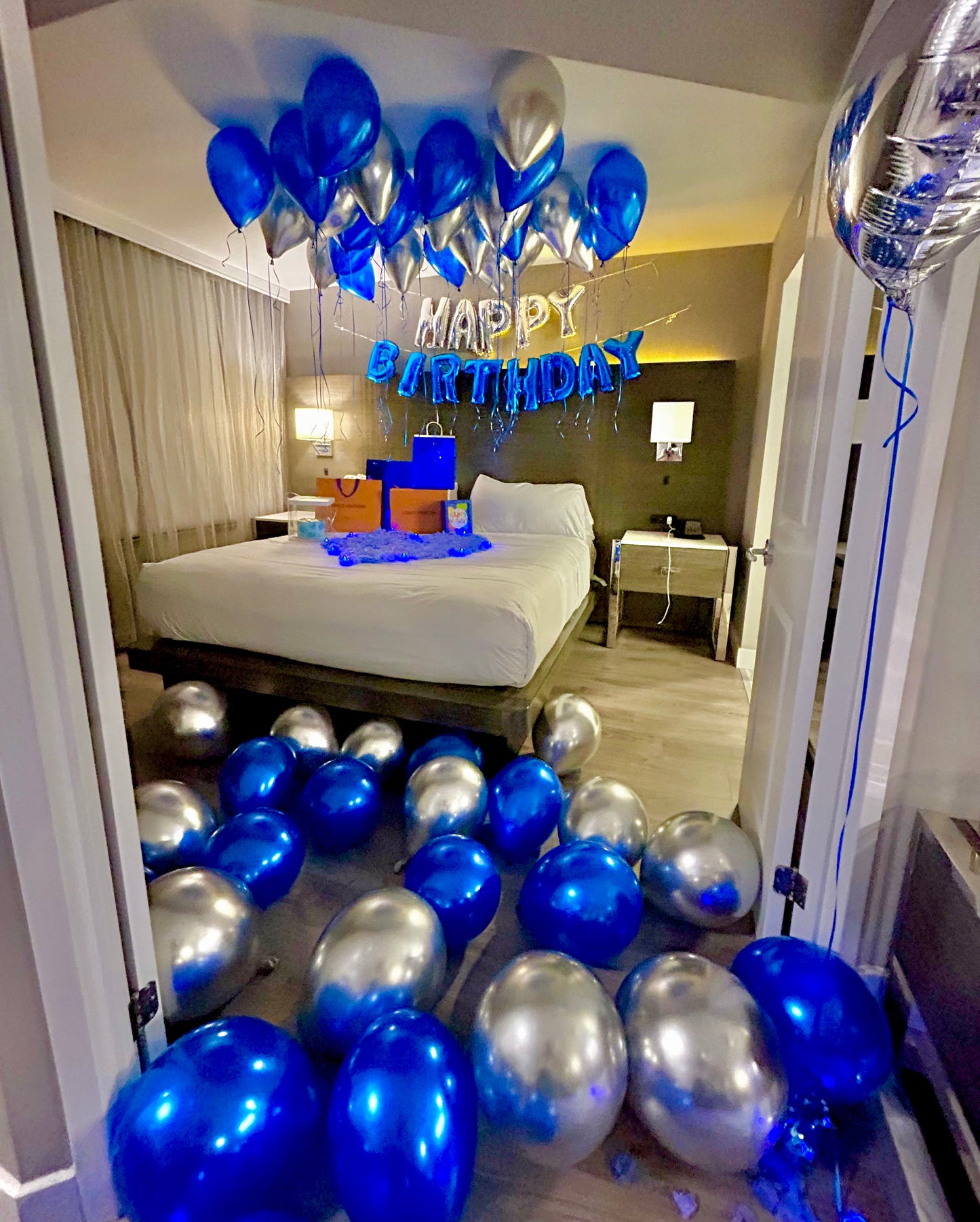 Blue & Silver Happy Birthday Balloon Decor with helium balloons, banner, and number stands.