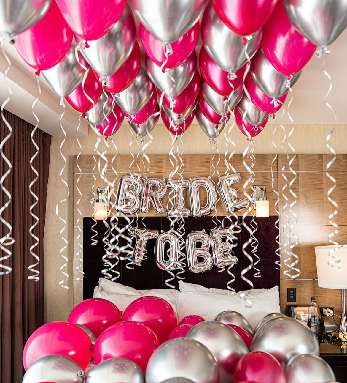Bride To Be room decor with ceiling and bed balloons, plus a "Bride To Be" balloon sign.