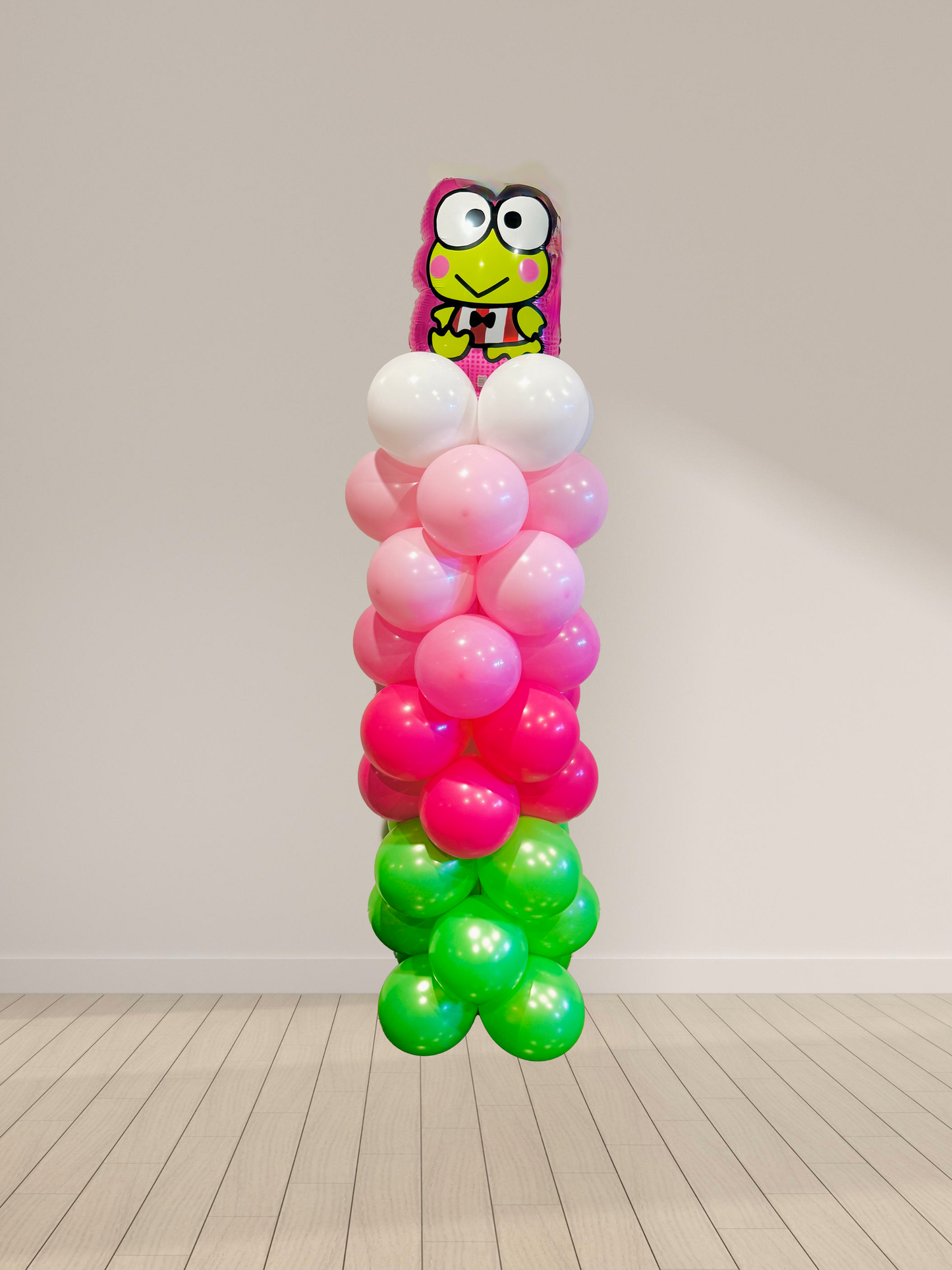 Balloon sculpture with a character on top against a plain background