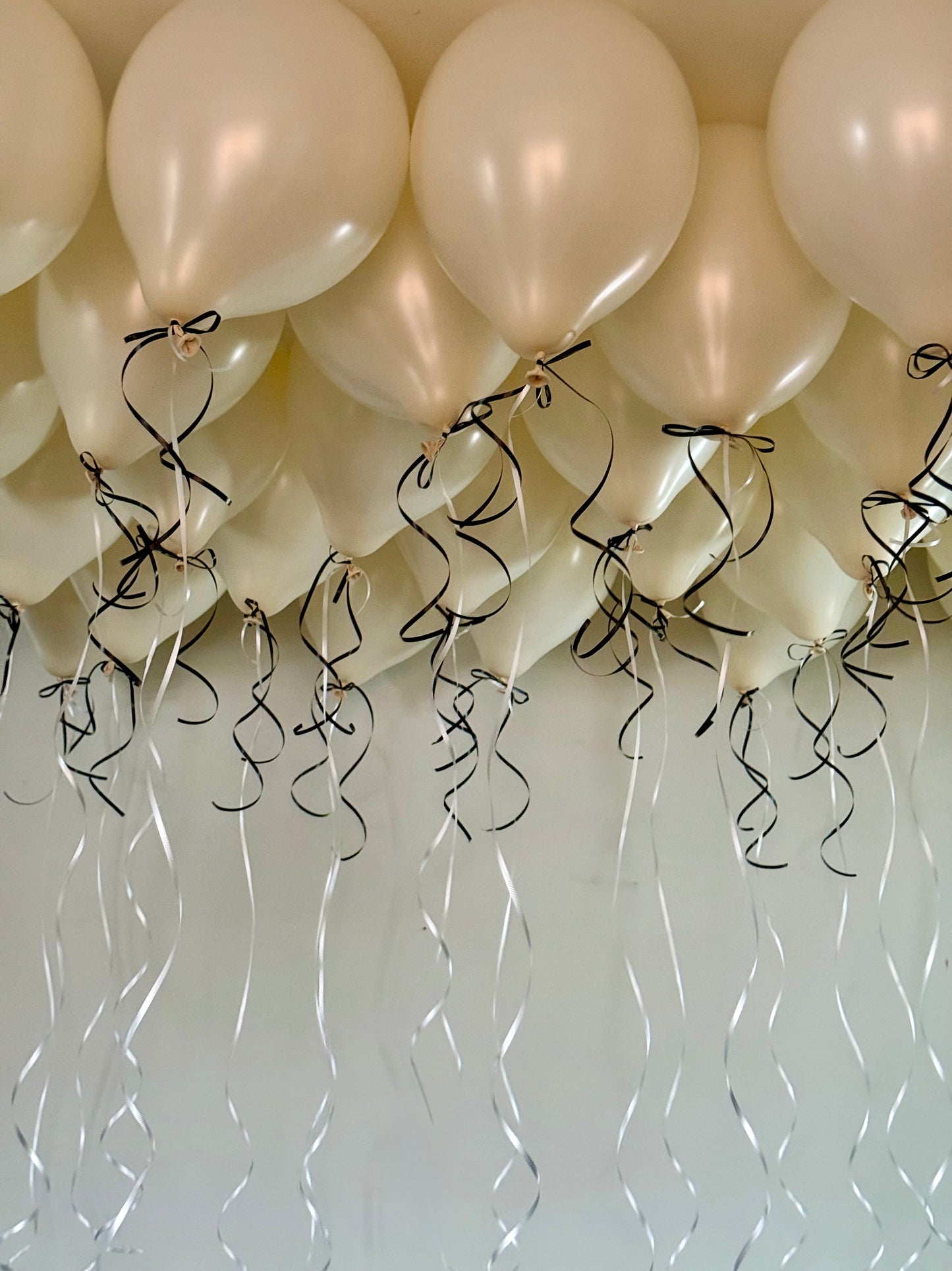 Coquette Balloons with helium-filled biodegradable balloons and decorative bows.