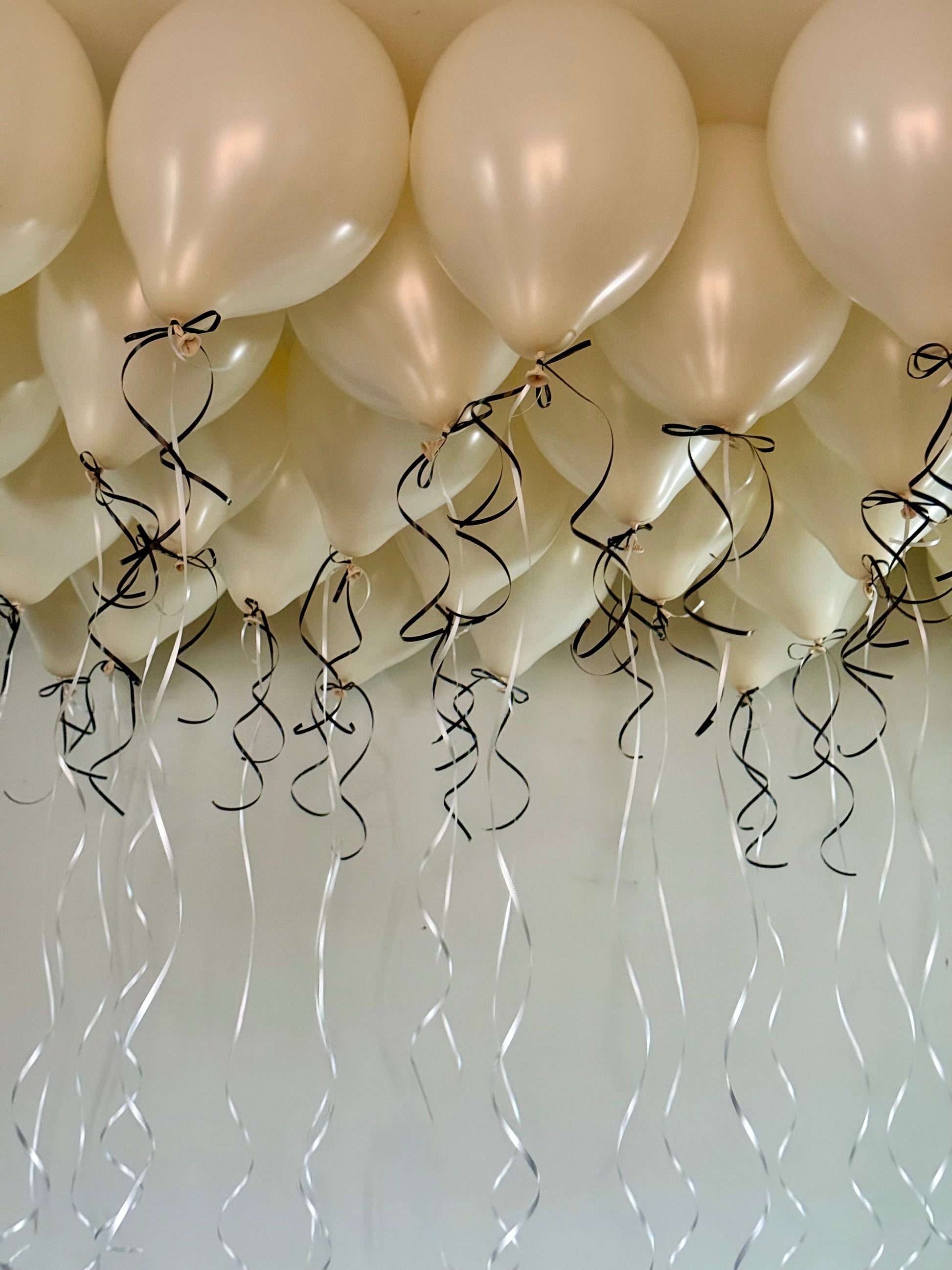 Coquette Balloons with helium-filled biodegradable balloons and decorative bows.