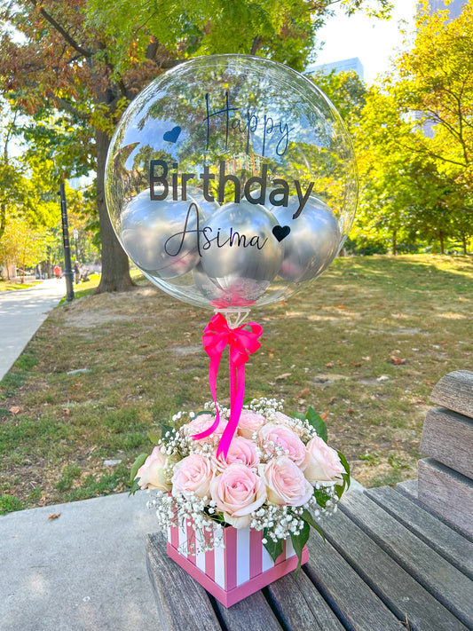 Bloom Box featuring roses, baby’s breath, and a clear customizable bobo balloon