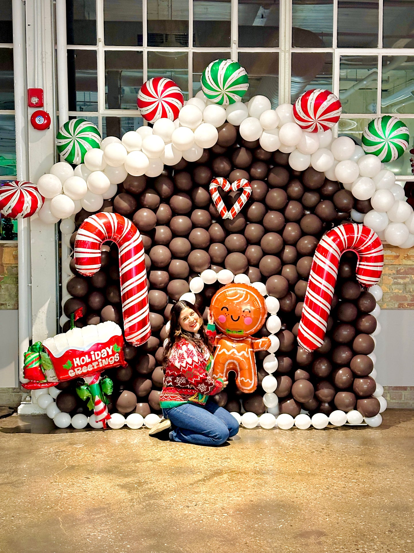 Gingerbread Balloon House with festive balloons and holiday decorations.