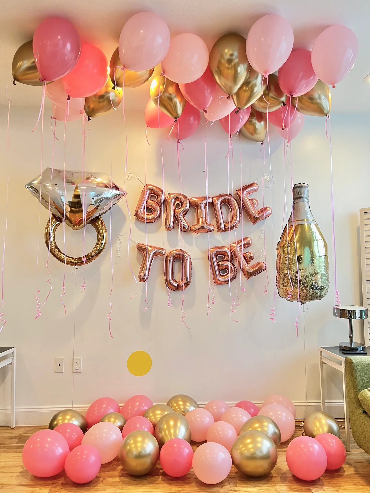 Bride Decor with helium-filled balloons, champagne bottle, and a “Bride To Be” banner for a bridal celebration.