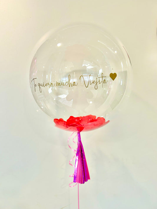 Clear Bubble Balloon with custom message, helium-filled, with mini balloons, confetti, or petals inside, including a tassel, bow, and balloon weight.