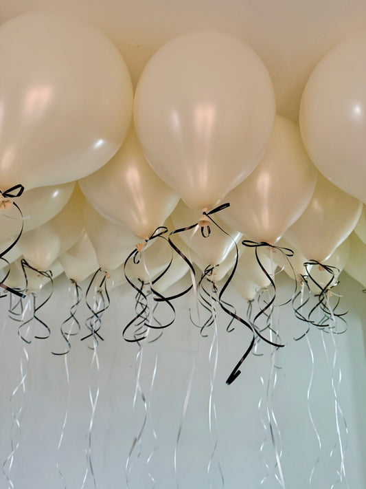 Coquette Balloons with helium-filled biodegradable balloons and decorative bows.