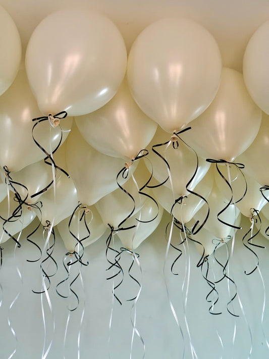 Coquette Balloons with helium-filled biodegradable balloons and decorative bows.