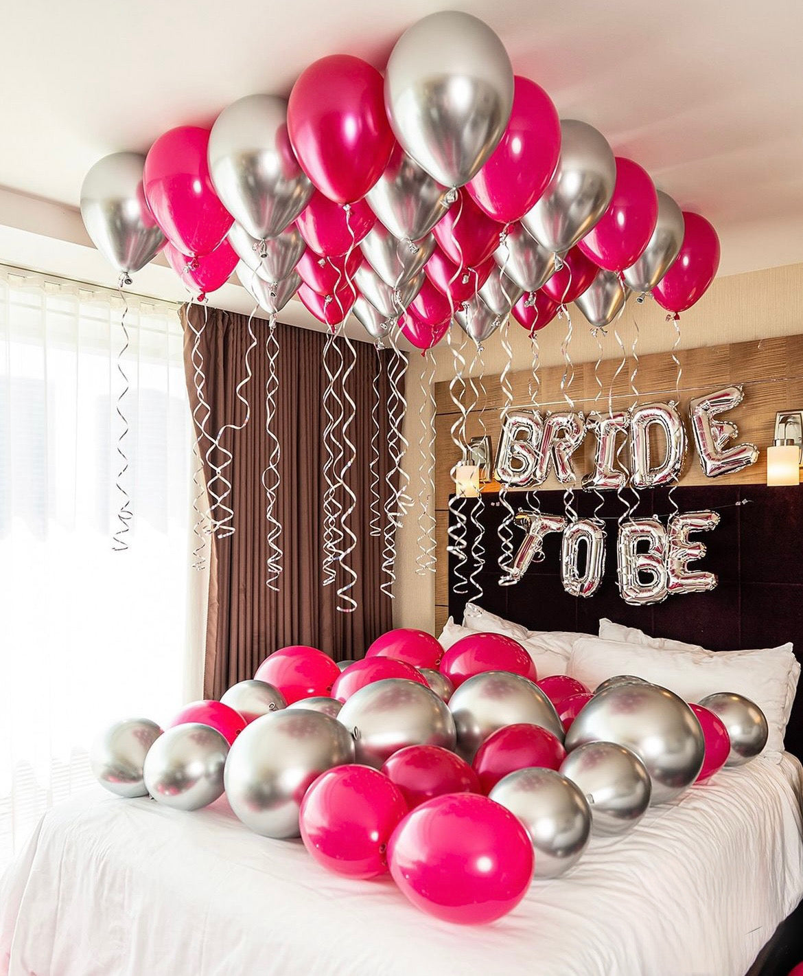 Bride To Be room decor with ceiling and bed balloons, plus a "Bride To Be" balloon sign.