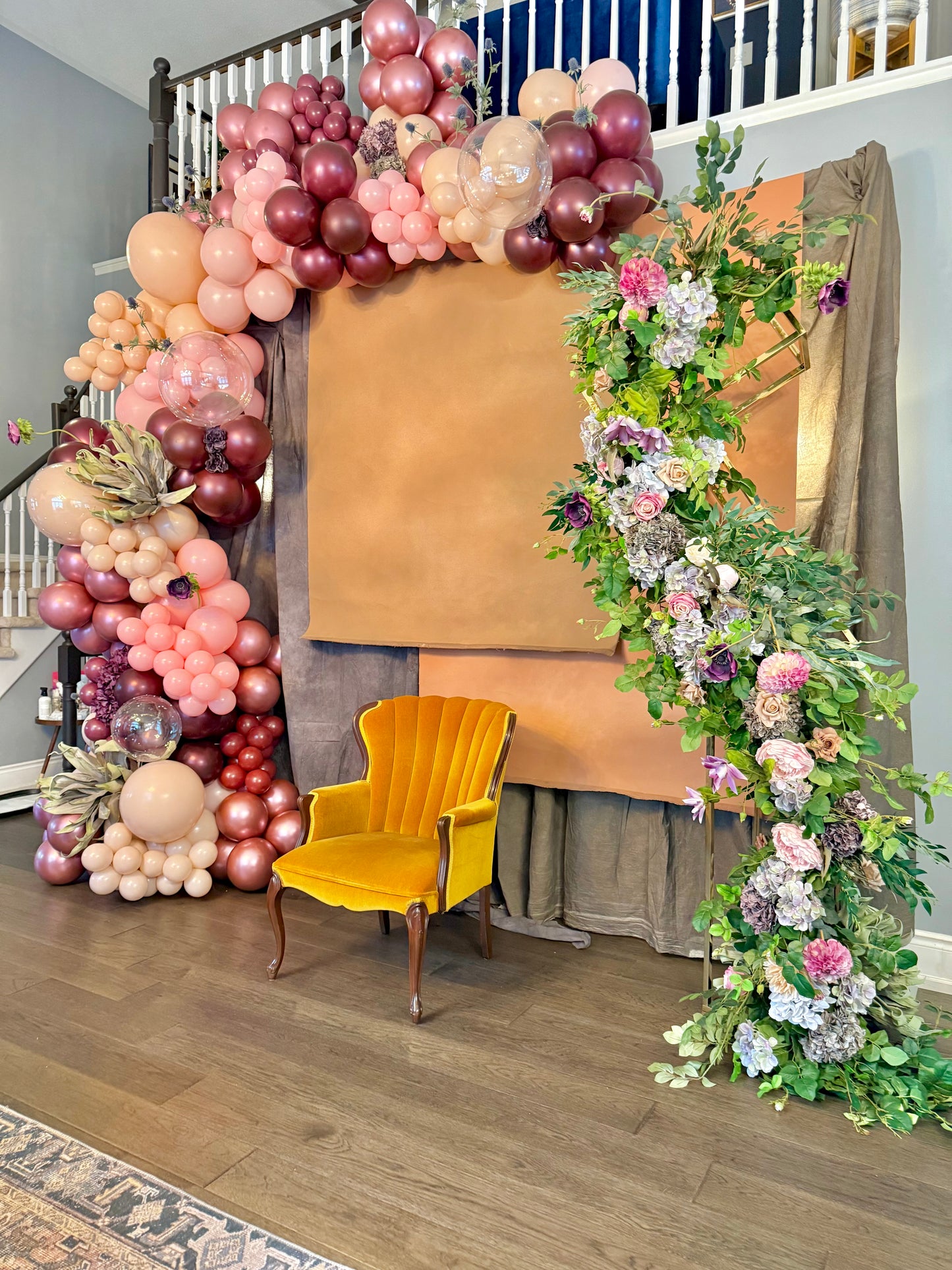 Luxury spring floral balloon garland with blush, gold, and greenery for elegant event decor.