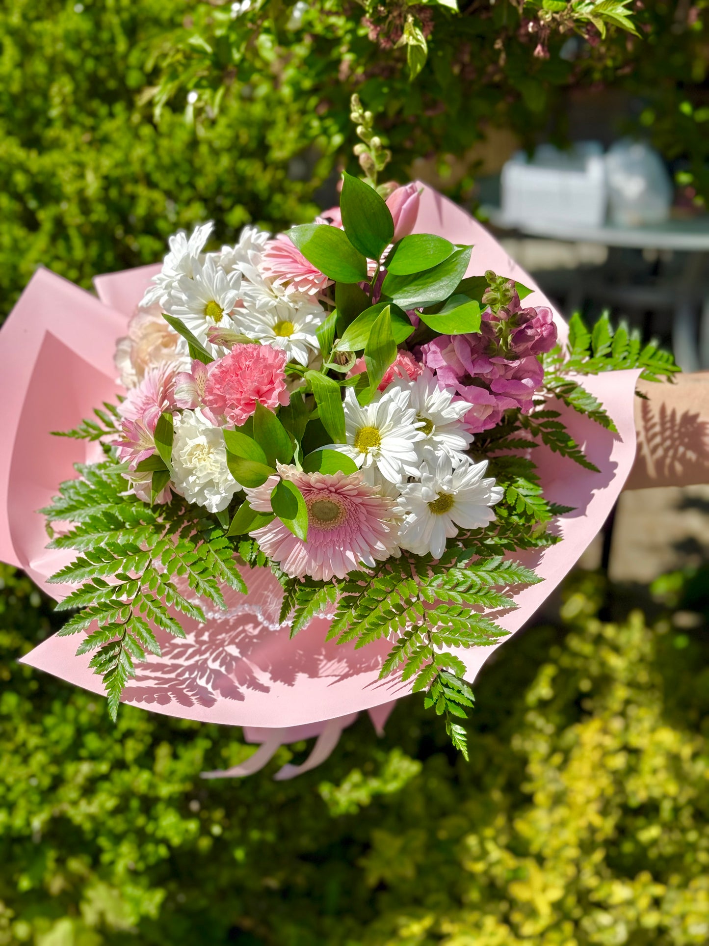 Bouquet of flowers wrapped in pink paper for Mother's Day.