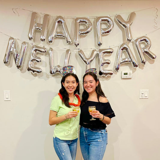 Happy New Year Balloon Banner in gold and silver with 16-inch air-filled letters, professionally installed.