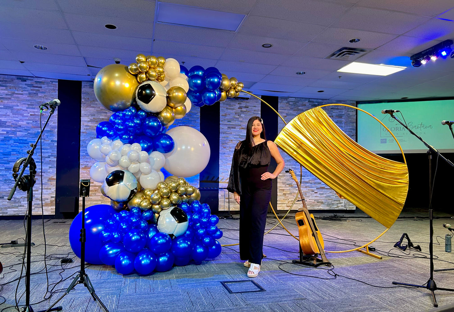 Luxury Soccer Balloon Backdrop with a gold arch, blue and white balloon arrangement, and soccer-themed decorations for a sports event.