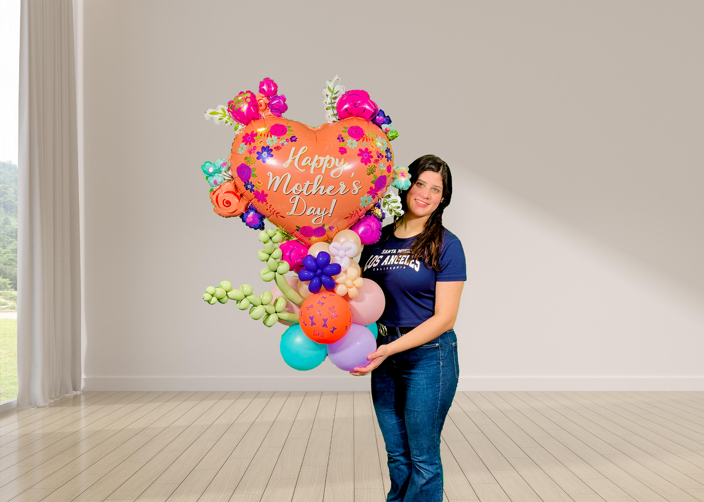Mother’s Day balloon stand with heart balloon, lavender twisting shapes, mini flowers, and hand-styled balloon base
