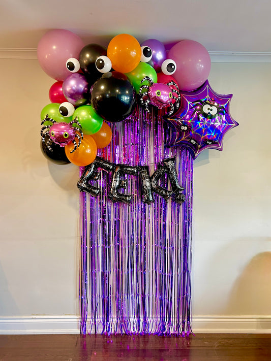Spider Halloween Balloon Decor with spooky balloons, spider web foil, and party curtain