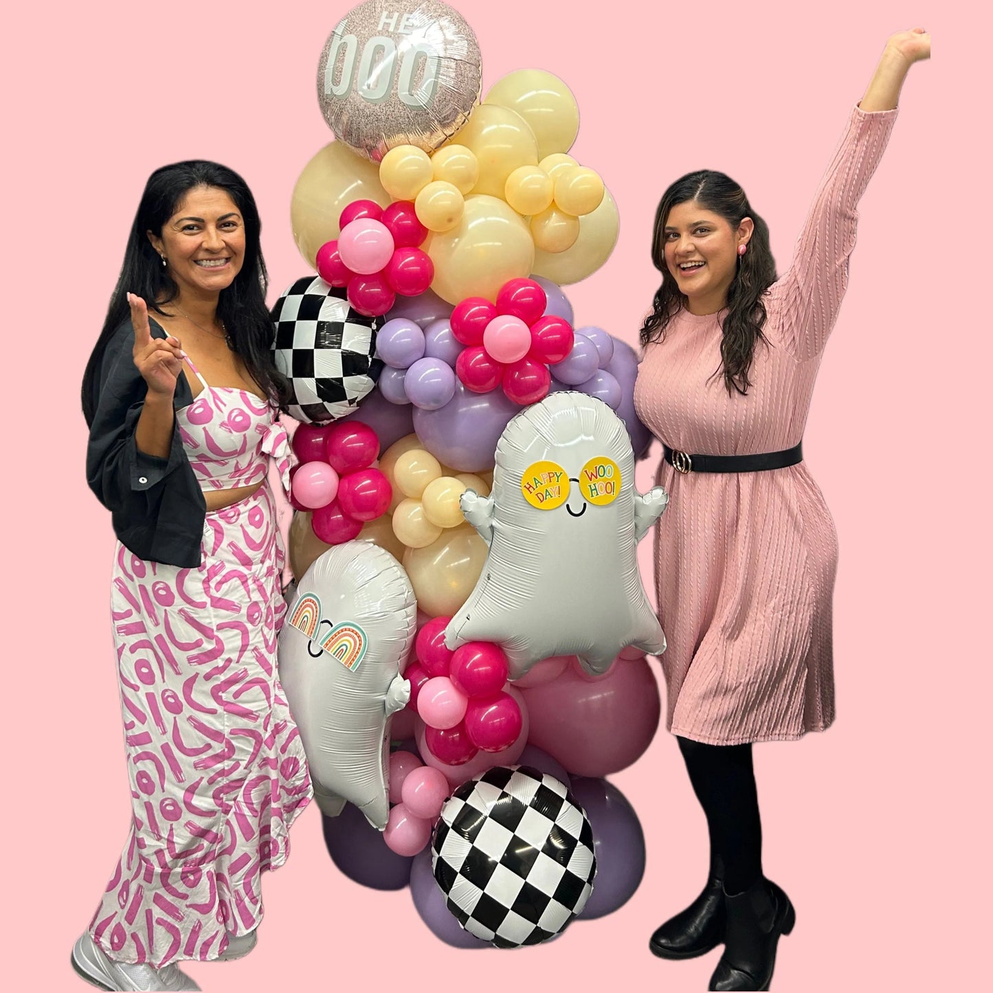 Spooky Chic Balloon Tower with ghost balloons, pastel colors, checkered accents, and a "Hey Boo" topper for Halloween celebrations.