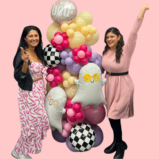 Spooky Chic Balloon Tower with ghost balloons, pastel colors, checkered accents, and a "Hey Boo" topper for Halloween celebrations.