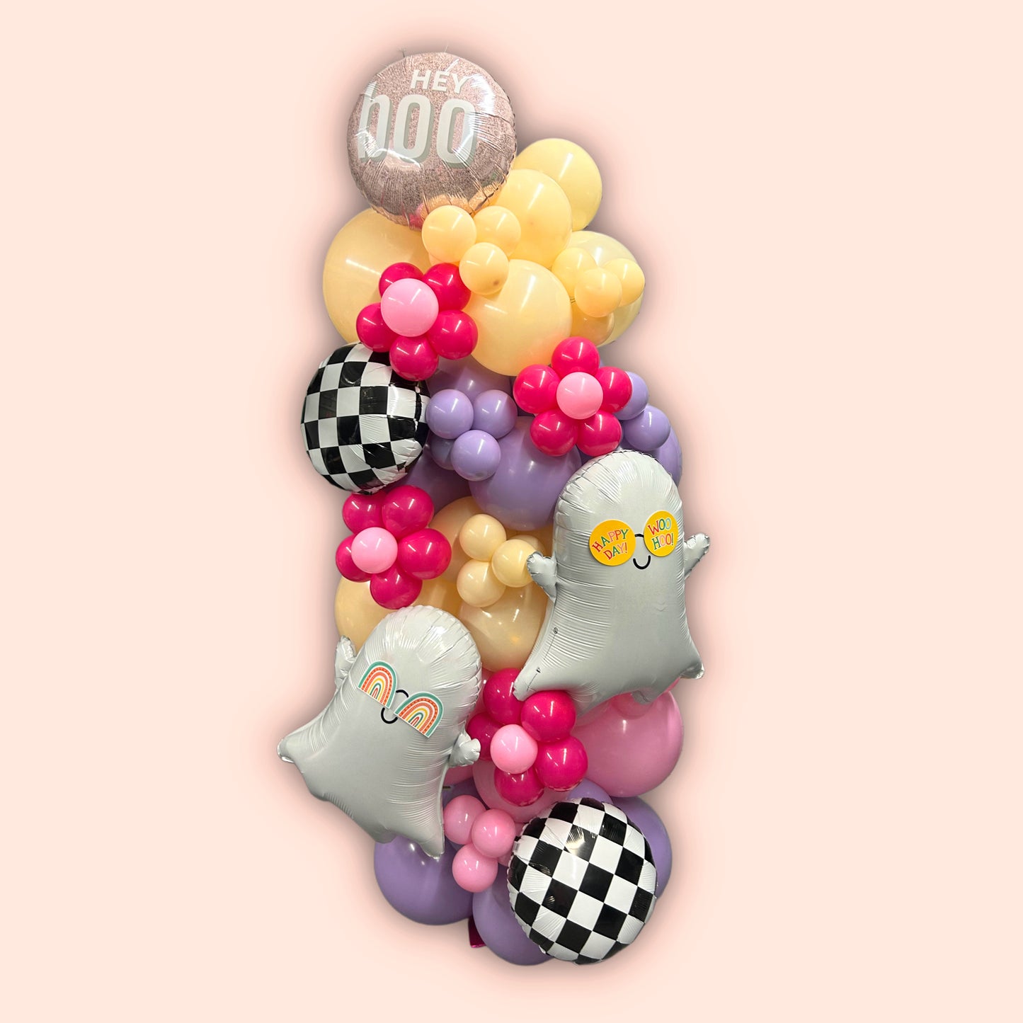 Spooky Chic Balloon Tower with ghost balloons, pastel colors, checkered accents, and a "Hey Boo" topper for Halloween celebrations.