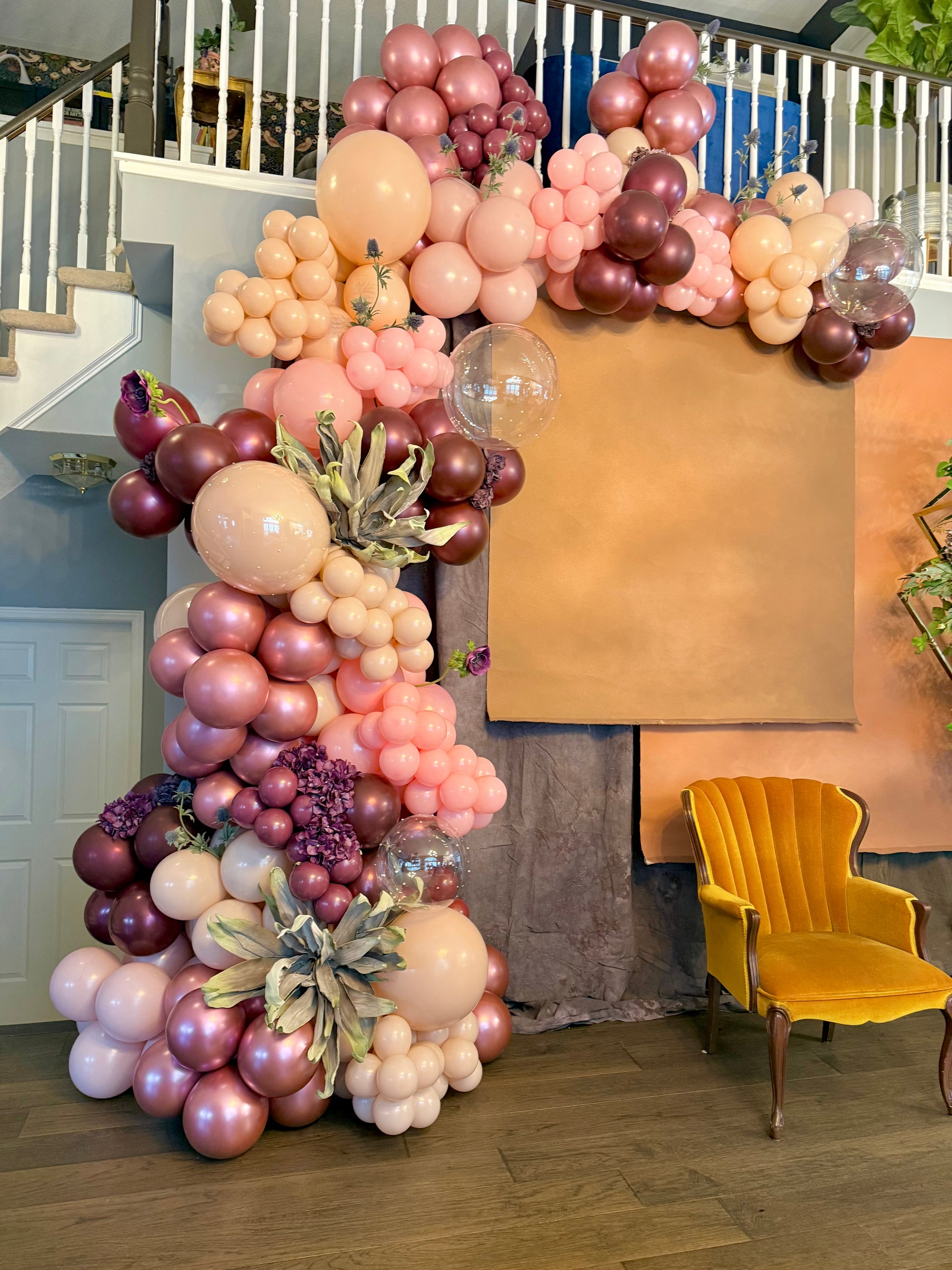 Luxury spring floral balloon garland with blush, gold, and greenery for elegant event decor.