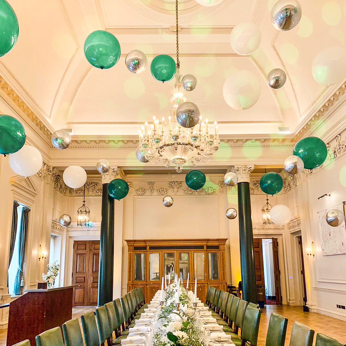 Suspended Floating Balloon Installation with giant and orbz balloons in a stunning event venue.