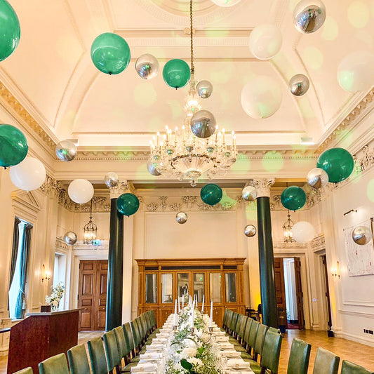 Suspended Floating Balloon Installation with giant and orbz balloons in a stunning event venue.