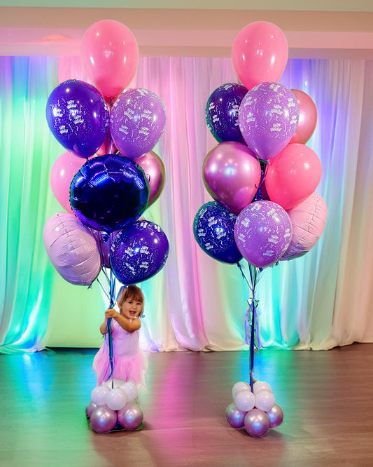 Wooow Jumbo Birthday Bouquets Toronto – large pink and purple birthday balloon bouquets with a child holding balloons, by Wooow Balloons