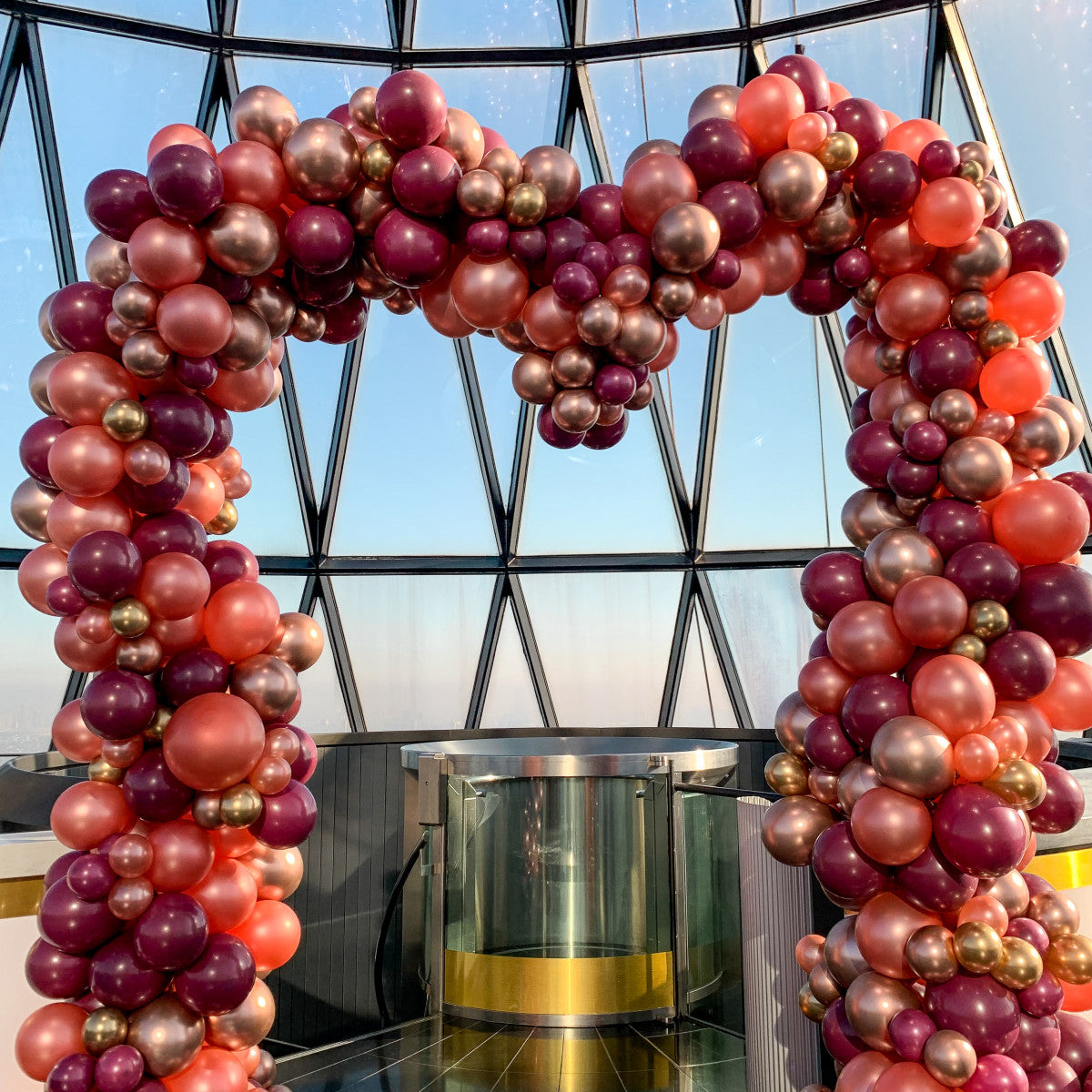 Customizable heart-shaped balloon arch in vibrant colors for weddings and celebrations.