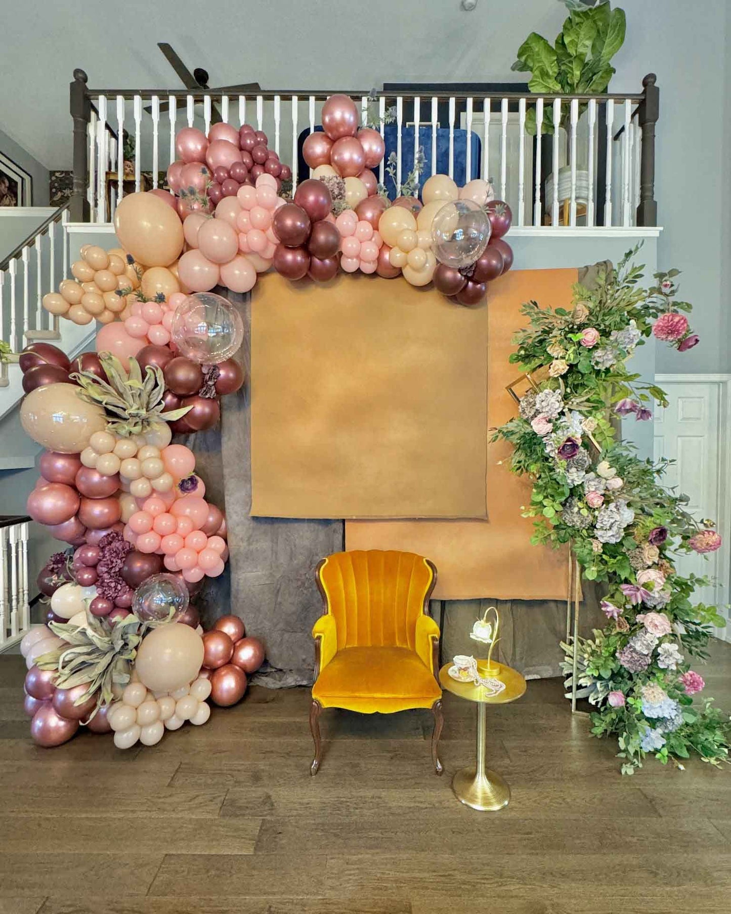 Custom Balloon Garland Toronto – luxury rose gold balloon installation with floral arch backdrop for elegant events by Wooow Balloons