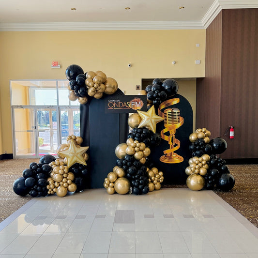 Luxury black and gold gala balloon installation with custom backdrop by Wooow Balloons Toronto.
