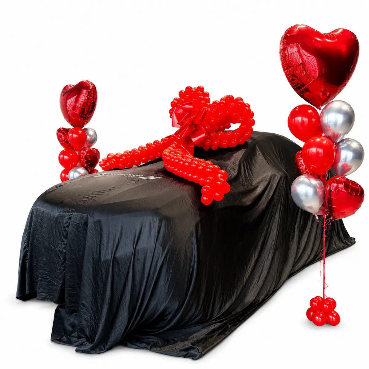 Covered BMW with a giant red balloon bow and red and silver heart balloon arrangements for a car reveal in Toronto.
