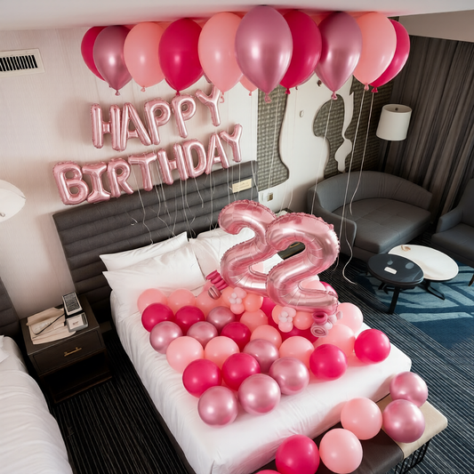 Hotel room balloon decor in Toronto featuring a birthday number display and balloon styling on the bed.