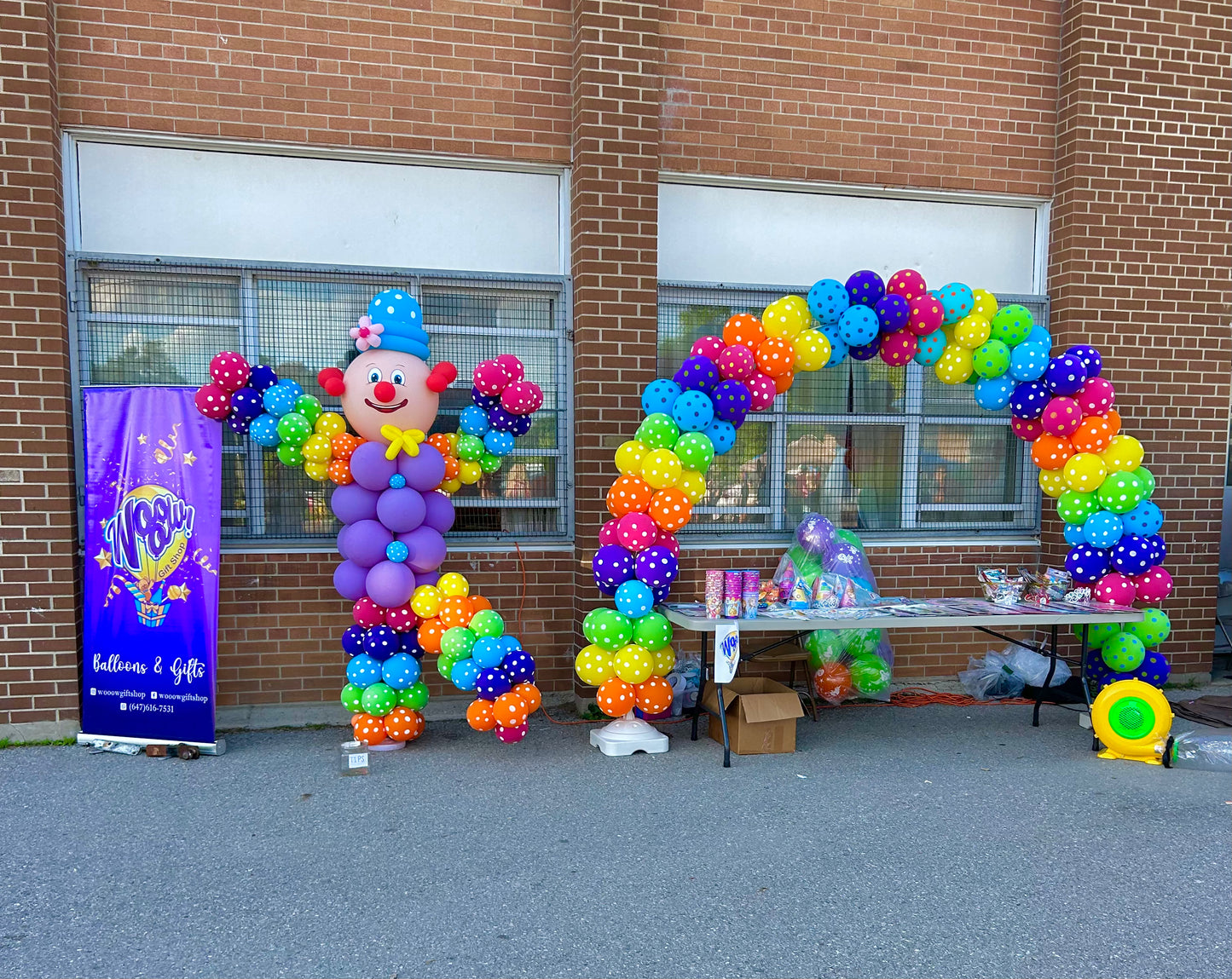Carnival Balloon Arch with a clown figure and a Bubble House filled with colorful balloons, perfect for events and parties.