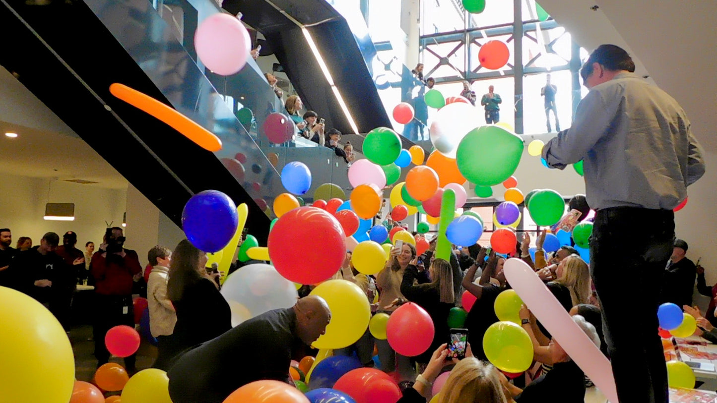 Overhead balloon drop with 360 colorful balloons for a spectacular celebration.
