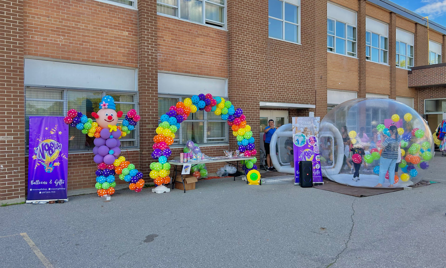 Carnival Balloon Arch with a clown figure and a Bubble House filled with colorful balloons, perfect for events and parties.