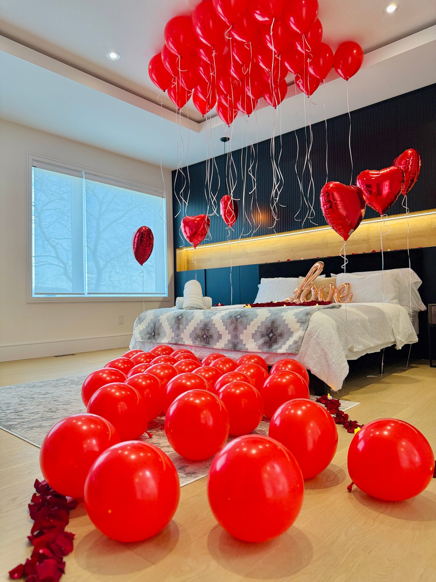 Proposal and anniversary room setup with balloons hearts petals and LED candles in the GTA