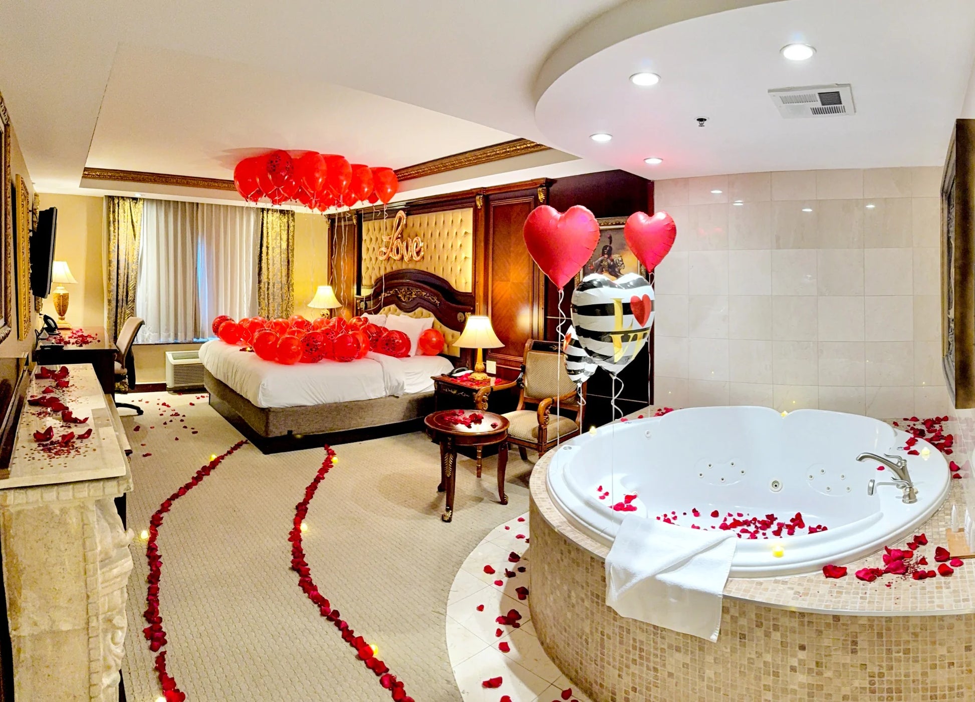 Romantic bedroom setup with floating red balloons and “Love” sign – Valentine’s Day decor in Toronto by Wooow Balloons.