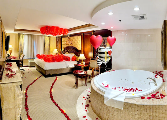 Romantic bedroom setup with floating red balloons and “Love” sign – Valentine’s Day decor in Toronto by Wooow Balloons.