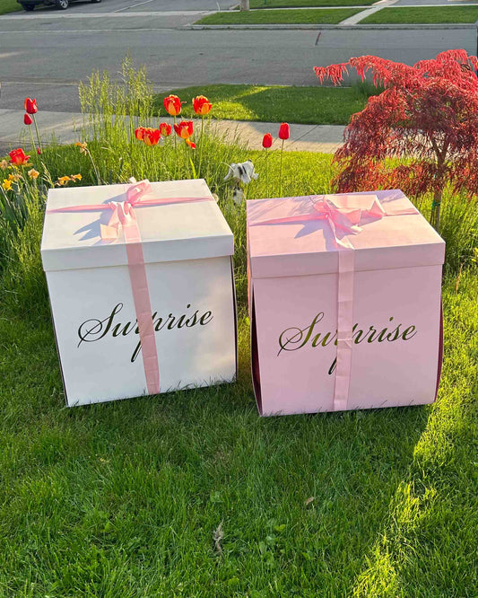 Surprise balloon gift box Toronto – luxury pink and white boxes with ribbons for birthday or celebration delivery by Wooow Balloons