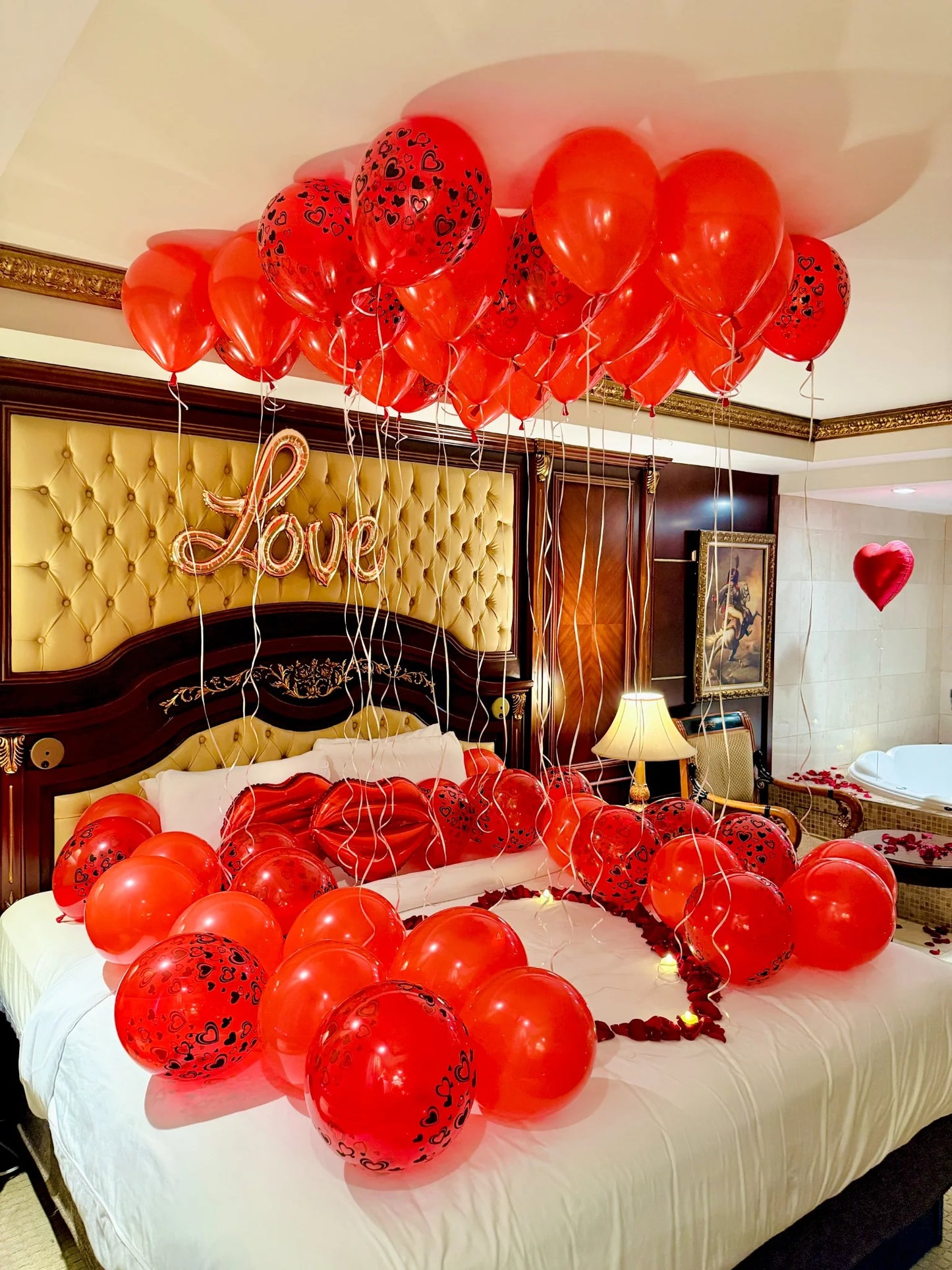 Valentine’s hotel room decoration with red balloons, roses, and warm lighting – romantic setup in Toronto