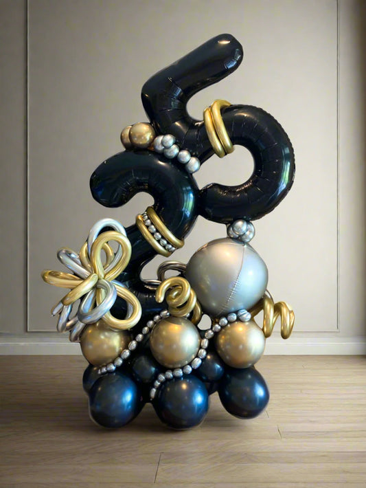 Elegant number balloon arrangement in black, gold, and silver, perfect for milestone celebrations.