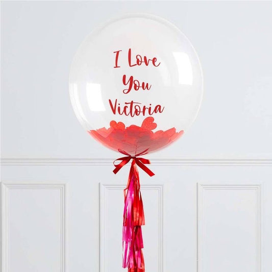 Customizable Bobo Balloon with tassels, a bow, and mini balloons or confetti inside, perfect for events and celebrations.