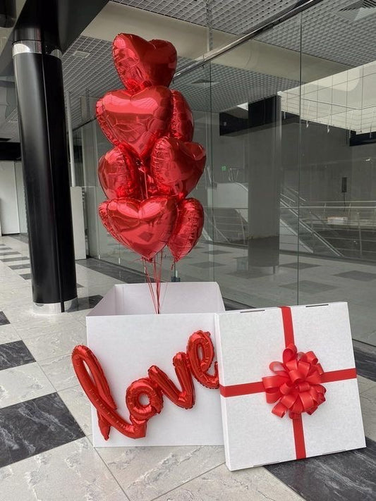 Red Hearts Love Box with 10 red heart balloons, love balloon sign, and red bow.