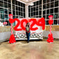 Christmas Balloon Numbers and Light Stands Decor with festive candy cane accents and gingerbread house backdrop.