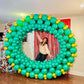 Giant Christmas Balloon Wreath made with biodegradable balloons, customizable design, 10ft size with a red or gold bow.