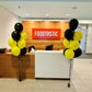 Front desk area with 'Foodtastic' sign and balloons in a modern office setting