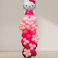 Balloon sculpture of Hello Kitty against a plain background