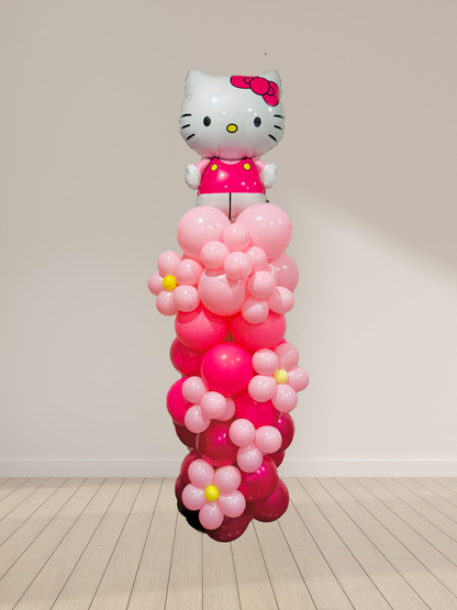 Balloon sculpture of Hello Kitty against a plain background