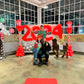 Christmas Balloon Numbers and Light Stands Decor with festive candy cane accents and gingerbread house backdrop.