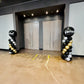Two decorative arches with balloons on either side of a door in a room.